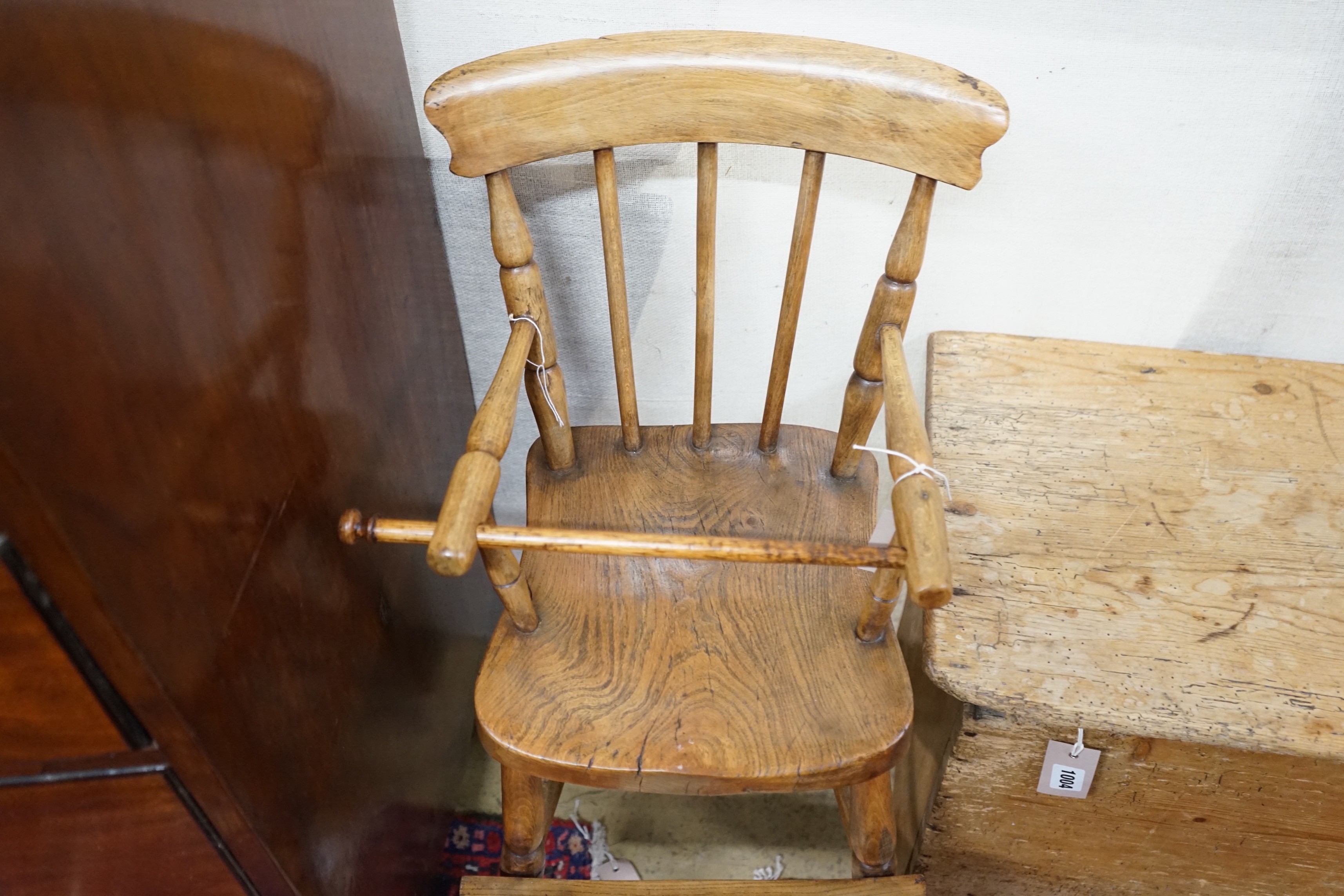 A Victorian elm and beech Windsor comb back child's high chair, height 84cm